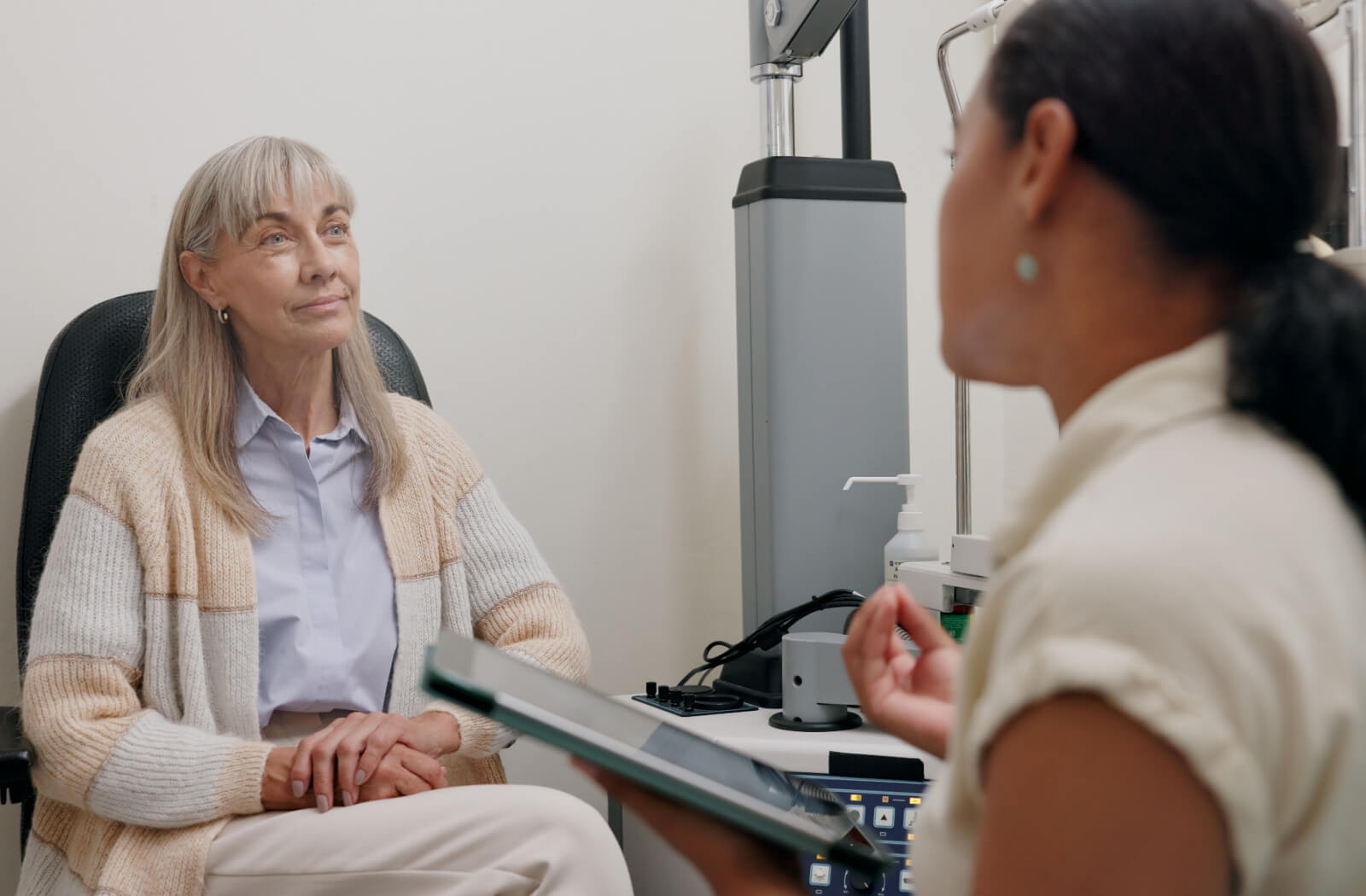 An optometrist describing the cause of dryness and irritation to a patient after a dry eye exam.
