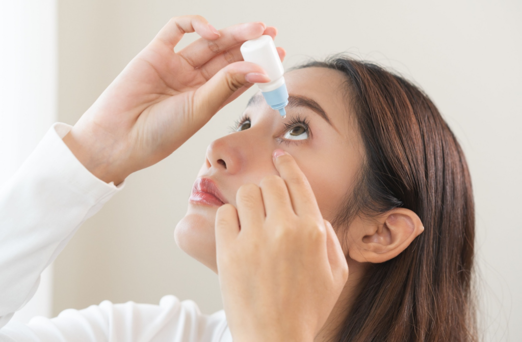 Adult applying eye drops to alleviate dry eye symptoms